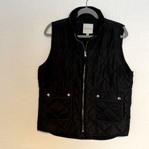 Black vest with gold zipper and pocket snaps